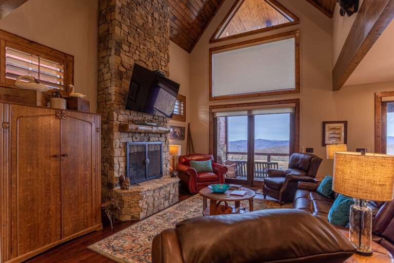 Rustic Living Room With Stone Fireplace And Mountain View Rustic Living Room With Stone Fireplace And Mountain View