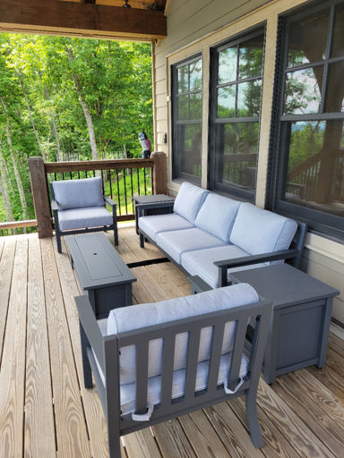 Outdoor Patio Furniture On Wooden Deck With Trees In Background