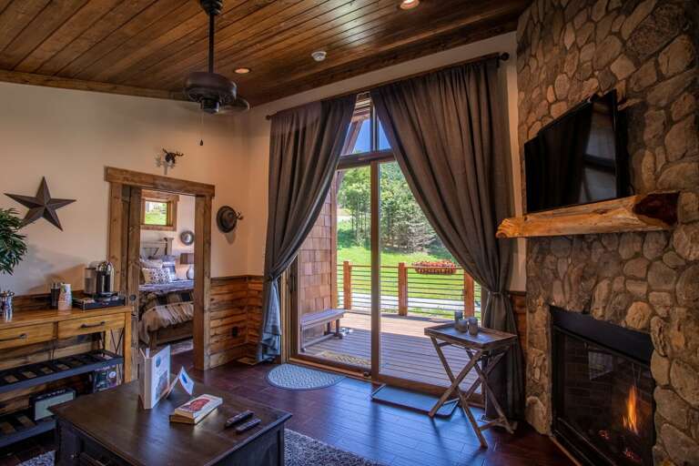 Rustic Room With Fireplace And Deck Access