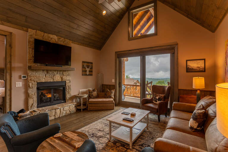 Living Room Interior With Fireplace And Balcony View In Vacation Rental