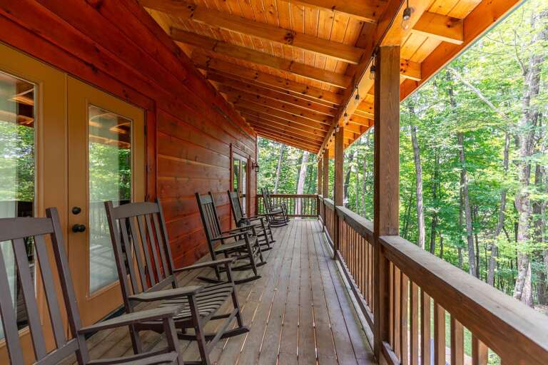 Wooden Porch With Rocking Chairs Overlooking Trees Wooden Porch With Rocking Chairs Overlooking Trees