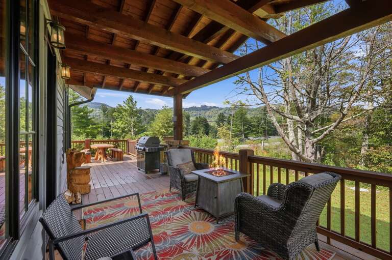 Cool autumn air, mountain colors on the horizon, and a cozy fire table waiting for you on the covered deck at Banner Sky.