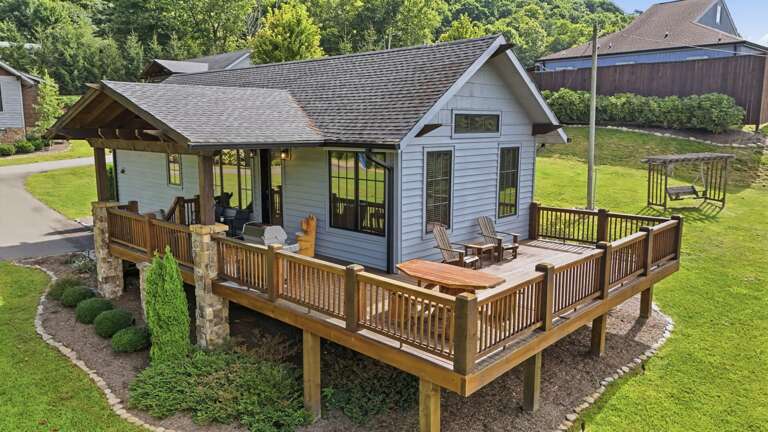 Exterior porch view of Banner Sky with picnic table, chairs, and grill