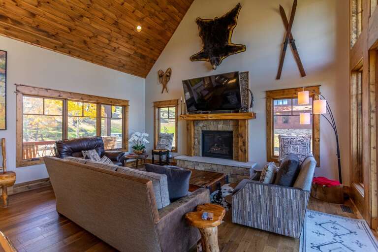 Rustic-style Living Room With Fireplace And Mounted Animal Heads