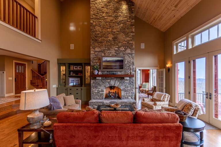 Interior Of A Living Room With Fireplace And High Ceiling In A Vacation Rental