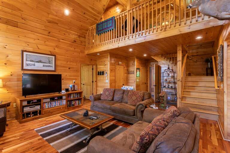 Wooden Cabin Interior With Living Area And Loft