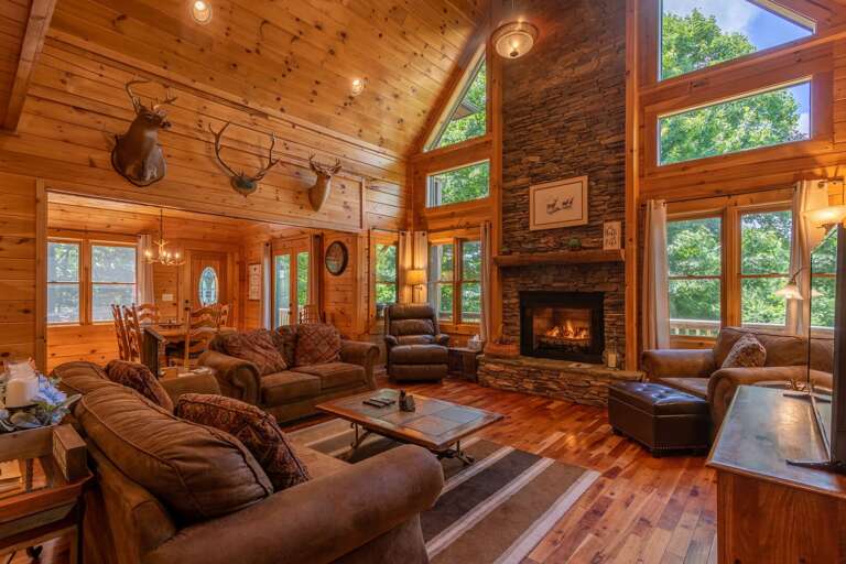 Wooden Cabin Interior With Fireplace And Furniture