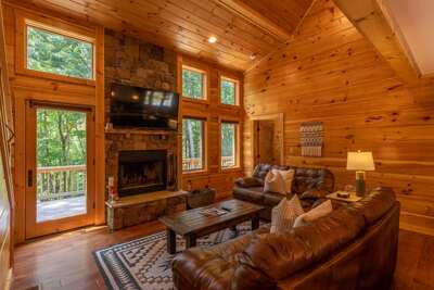 Wooden Cabin Interior With Fireplace And Furniture