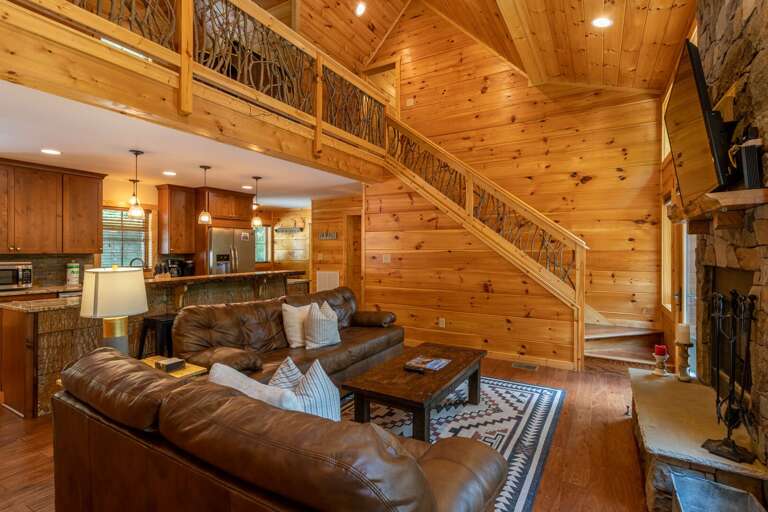 Wooden Interior Living Space With Staircase And Kitchenette