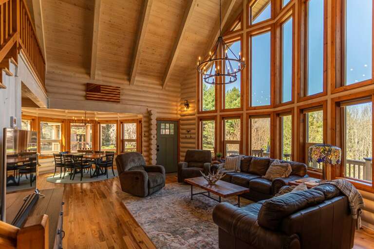Living Room With Large Windows And Wooden Interiors