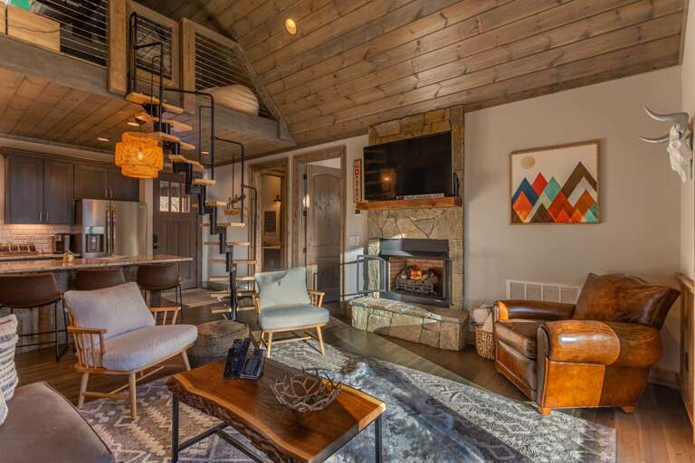 Wooden Interior Living Space With Fireplace And Kitchen Wooden Interior Living Space With Fireplace And Kitchen