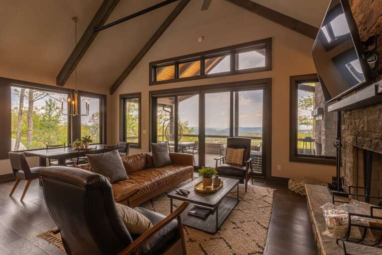 Interior Living Space With Fireplace And Lake View Through Large Windows