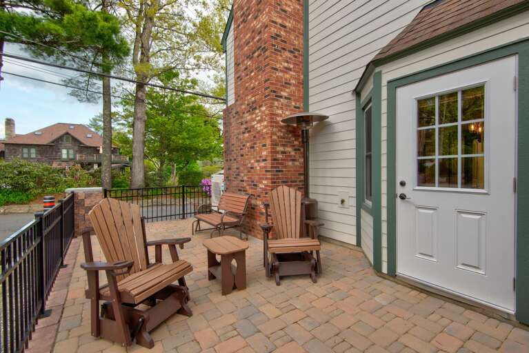Outdoor Patio With Chairs And Brick Wall