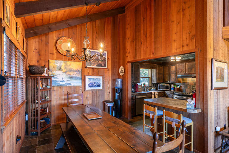 Wood-paneled Interior With Dining Table And Kitchen Wood-paneled Interior With Dining Table And Kitchen