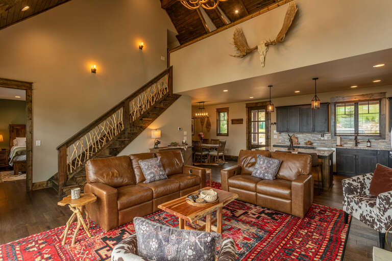 Interior Of A Vacation Rental Living Room With Stairs And Kitchen
