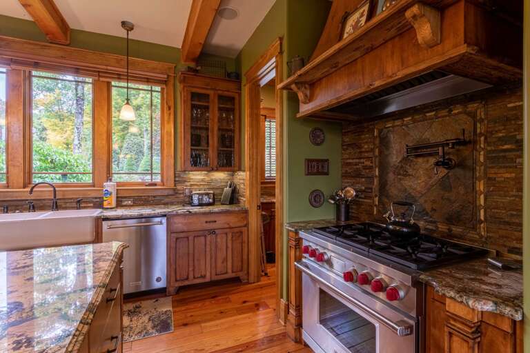 Fully stocked kitchen with gas range, double oven, dishwasher and walk in pantry.