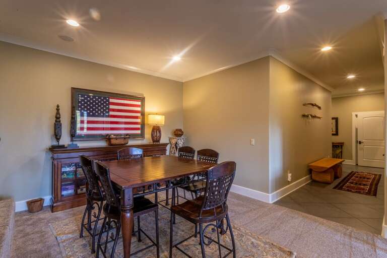 Lower level theater room and seating area with game table and pool table.