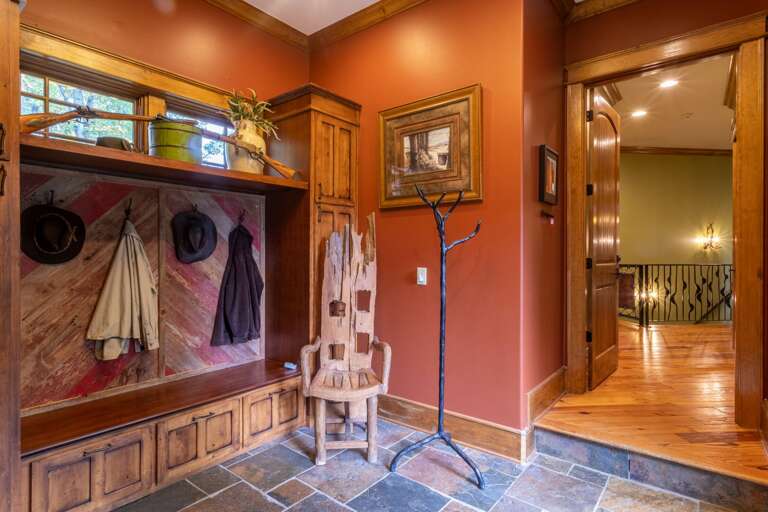 Main level entrance with coat closet and second set of washer/dryer in closet. Entrance to two car garage as well.