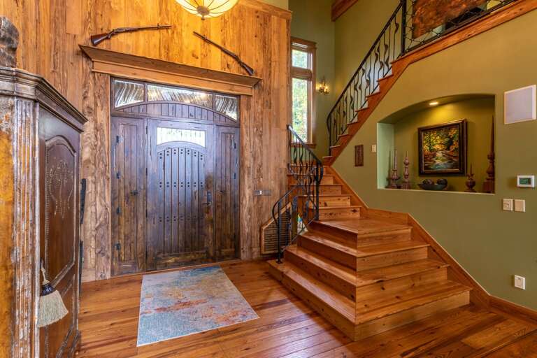 Main level front door entrance, stair case to upper level loft. Be sure to check out the secret kids room under the stairs.
