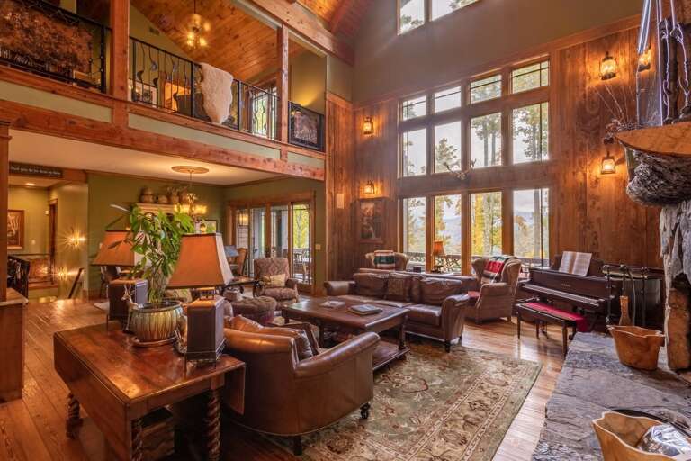 Main level living room with gas fireplace, smart TV, Sonos bar and self playing piano.