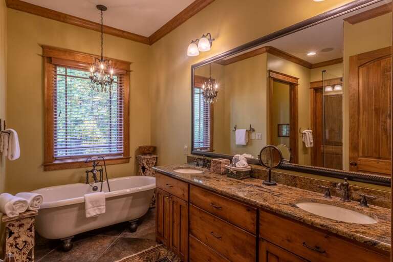 Main level master bedroom bathroom with double vanity, soaking tub and standing shower.