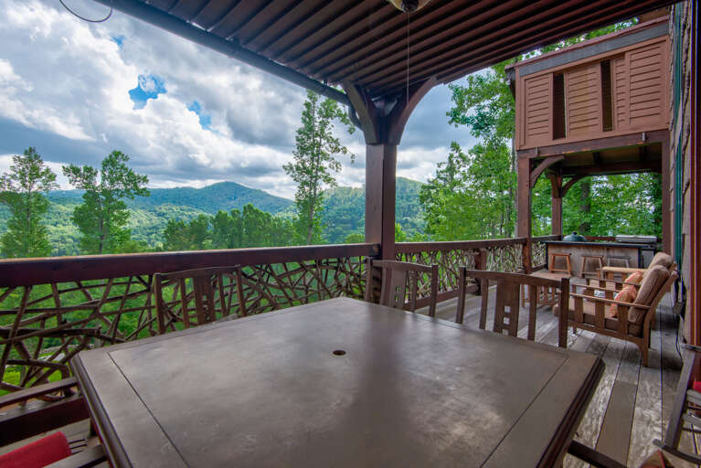Main level porch with seating and dining.