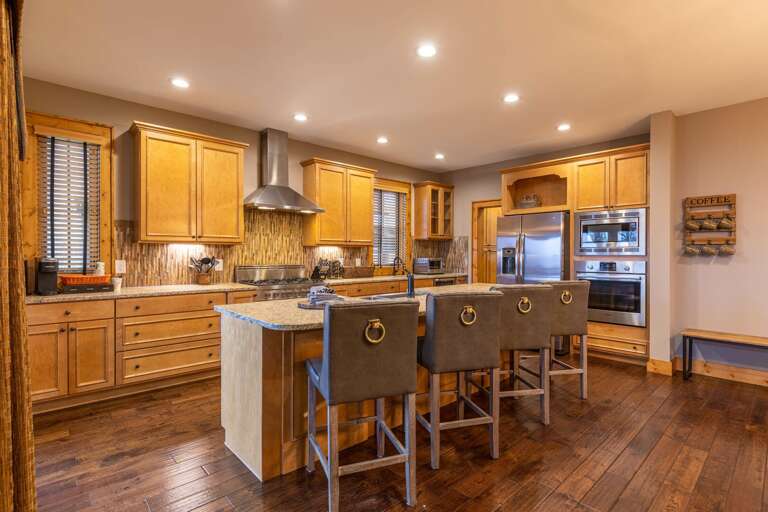 Wooden Kitchen Interior With Island And Stools
