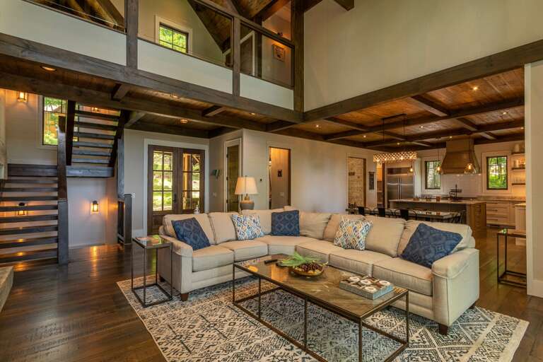 Interior Living Space With Sectional Sofa, Coffee Table, And Open Kitchen Area