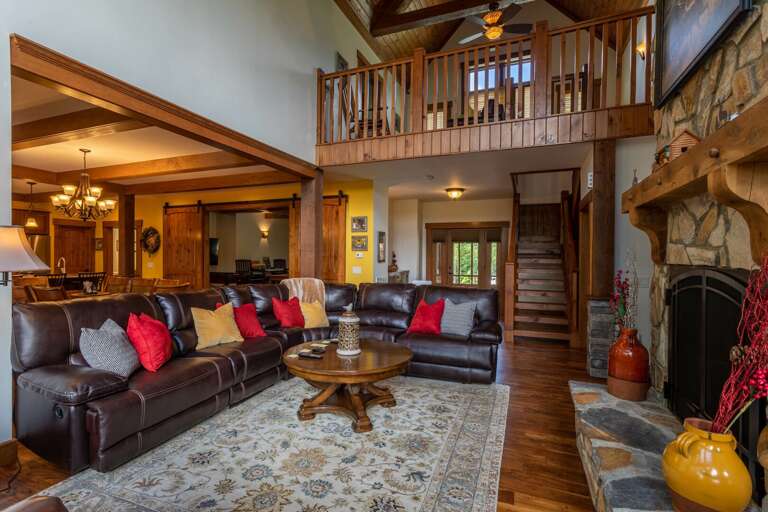 Interior Living Area With Staircase And Upper Balcony