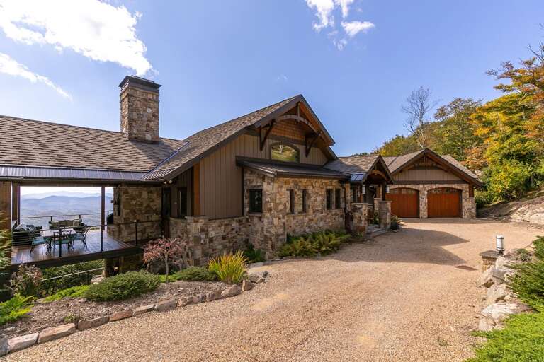 Residential House With Stone Detailing And Garage By The Mountainside