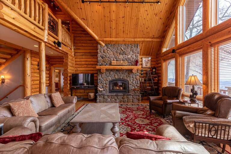 Wooden Cabin Interior With Fireplace And Furniture