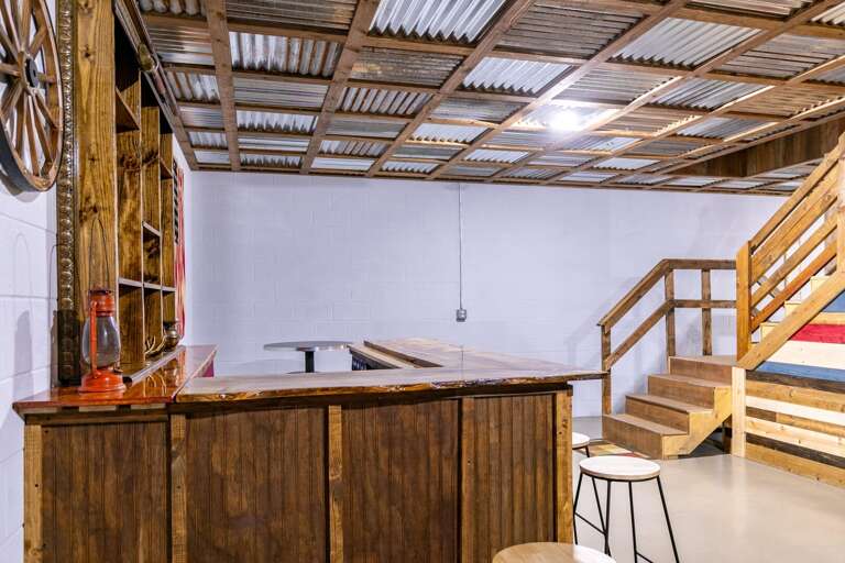 Rustic Room With Wooden Bar And Ladder To Loft
