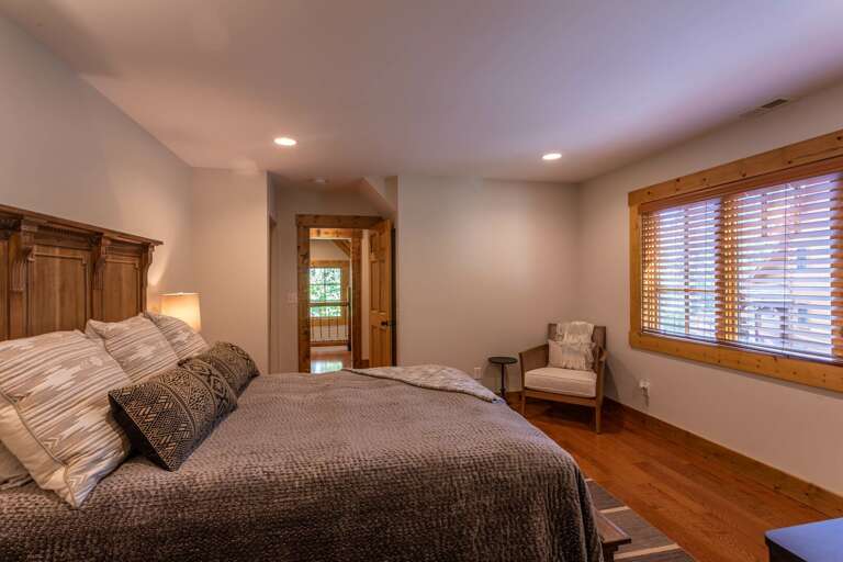 Detached guest quarter bedroom with queen bed and full bathroom.