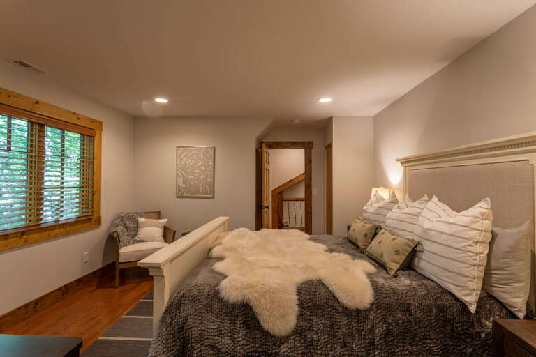 Detached guest quarter bedroom with queen bed and full bathroom.