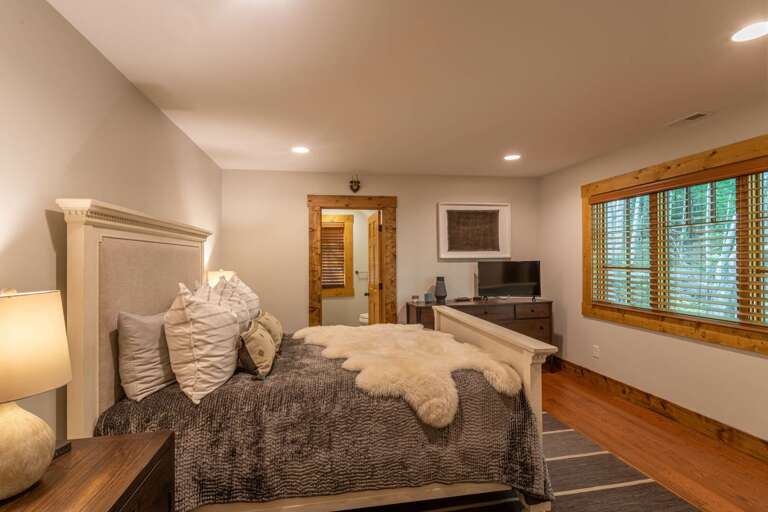 Detached guest quarter bedroom with queen bed and full bathroom.