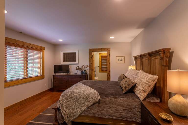 Detached guest quarter bedroom with queen bed and full bathroom.