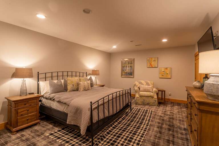 Lower level bedroom with king sized bed.