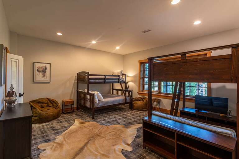 Lower level bunk room with 3 twin beds and 1 full.