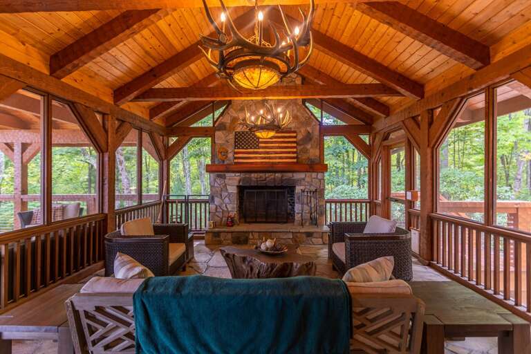 Main floor screened in covered porch with wood burning fireplace.