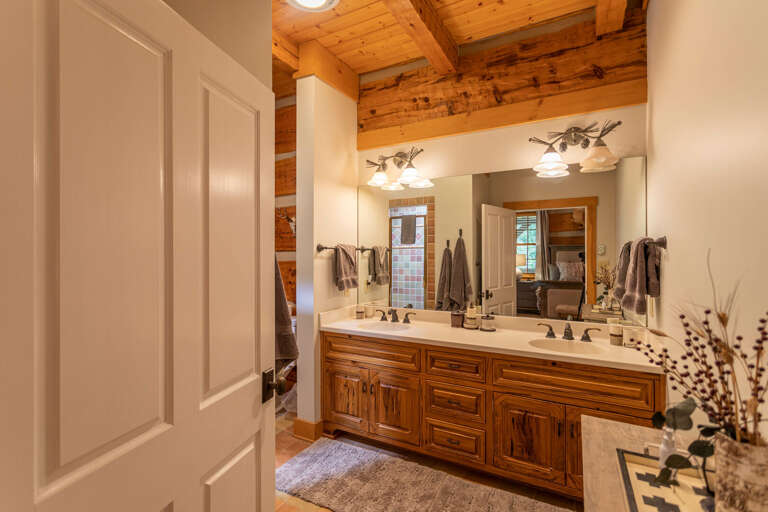 Main level master bedroom bathroom with double vanity and standing shower.