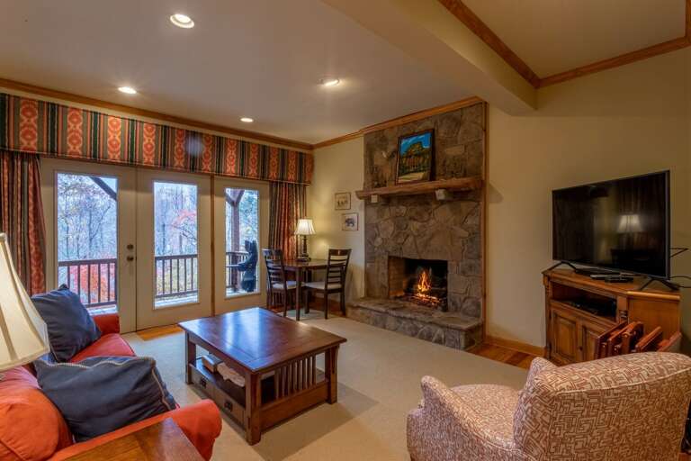 Downstairs living room are with another gas fireplace and flat screen TV.