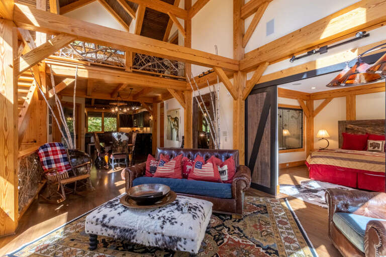 Rustic Interior With Wooden Beams, Furniture, And Patterned Textiles Rustic Interior With Wooden Beams, Furniture, And Patterned Textiles