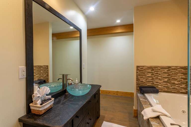 Main level master bedroom bathroom with jacuzzi tub and standing shower. Main level master bedroom bathroom with jacuzzi tub and standing shower.