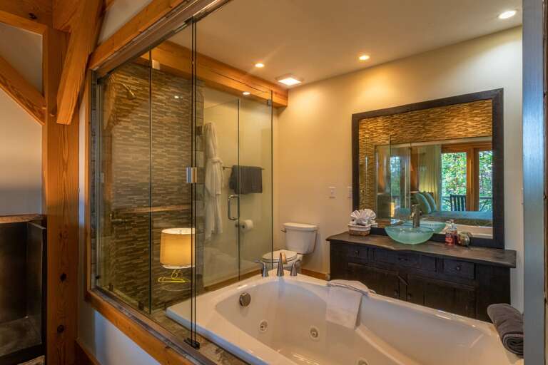 Main level master bedroom bathroom with jacuzzi tub and standing shower. Main level master bedroom bathroom with jacuzzi tub and standing shower.