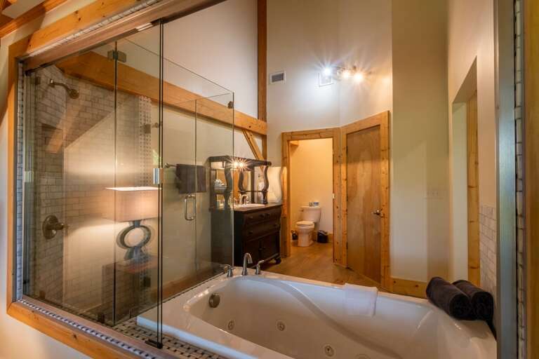 Upper level master bedroom bathroom with jacuzzi tub and standing shower. Upper level master bedroom bathroom with jacuzzi tub and standing shower.