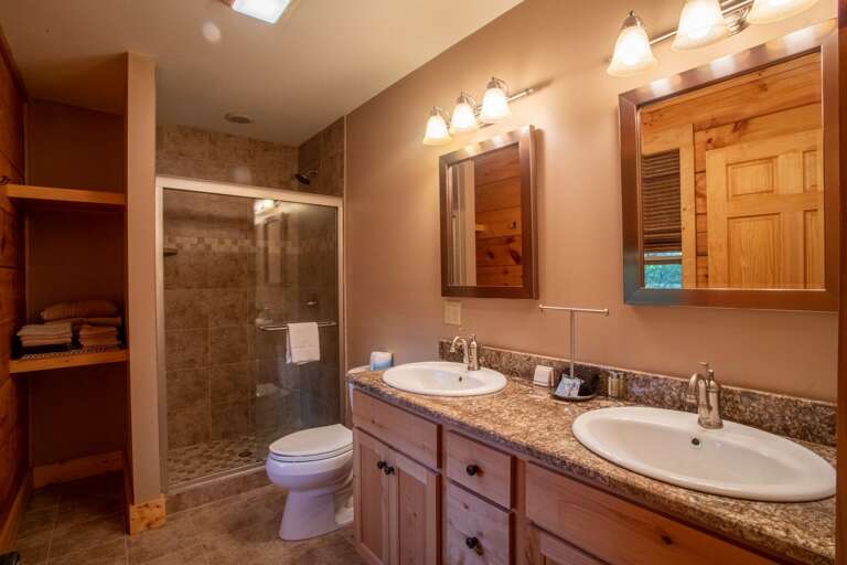 Master bathroom with tiled shower and double vanities