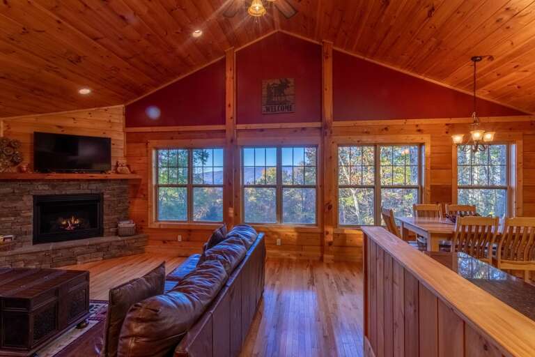 Wall of windows in living room allowing in natural light and beautiful views outside!