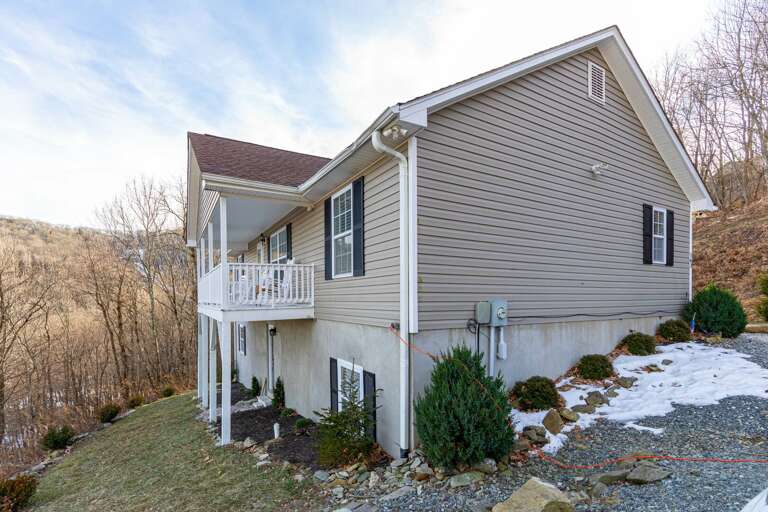 Vacation Rental Poised On A Grassy Knoll, Overlooking Leafless Trees