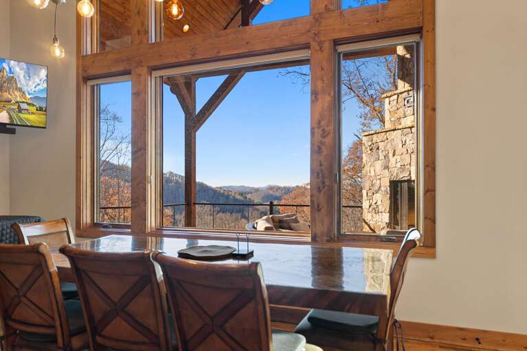 Mountain-view Room With Expansive Glass Walls And Rustic Stone Accents