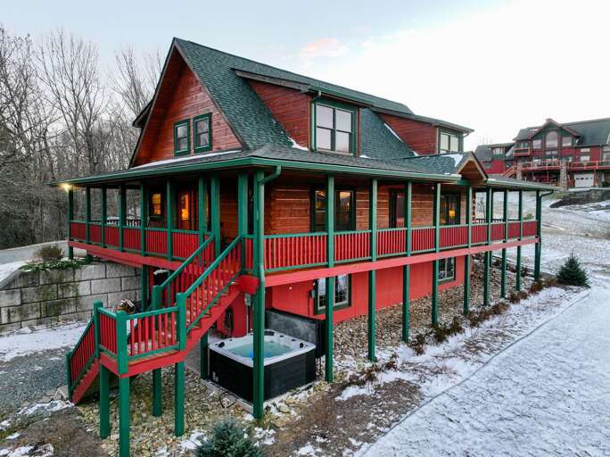 Red-roofed Residence Resting In Snowy Setting With Surrounding Structures